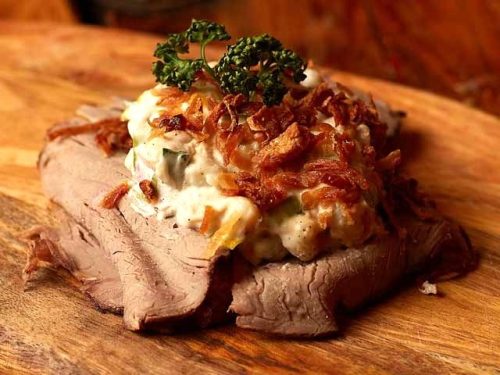 Smorrebrod Copenhagen Marinated Roast beef with rye bread, potato salad with leek, capris & roasted onion